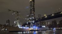 A masted Mexican Navy training ship, the CuauhtÃ©moc, sits stranded after colliding with the Brooklyn Bridge.