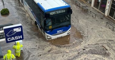Bus submerged in floodwaters.