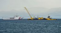 Italian Coast Guard ship assisting in the recovery of a sunken superyacht.