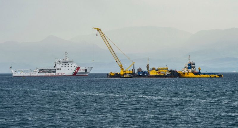 Italian Coast Guard ship assisting in the recovery of a sunken superyacht.