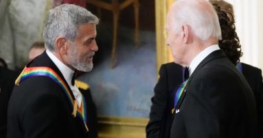 President Joe Biden shakes hands with actor, director and producer George Clooney during the Kennedy Center honorees reception at the White House in Washington, Dec. 4, 2022. Movie star and lifelong Democrat George Clooney is adding his voice to calls for Joe Biden to leave the presidential race. Clooney says in a New York Times opinion piece Wednesday that he loves Biden, but the party would lose the presidential race as well as any control in Congress with him as the nominee.