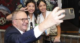 Prime Minister Anthony Albanese takes a selfie during a visit to the Sunnybank Market Square, in the electorate of Moreton, in Sunnybank, Queensland.