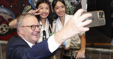 Prime Minister Anthony Albanese takes a selfie during a visit to the Sunnybank Market Square, in the electorate of Moreton, in Sunnybank, Queensland.
