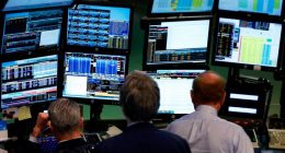 Traders work at Bloomberg terminals on the floor of the New York Stock Exchange