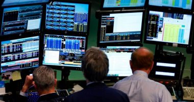 Traders work at Bloomberg terminals on the floor of the New York Stock Exchange