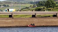 Underwater search team in a boat at a reservoir.