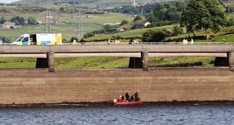 Underwater search team in a boat at a reservoir.