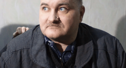Portrait of a man in a dark jacket.