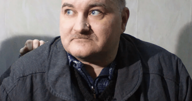 Portrait of a man in a dark jacket.