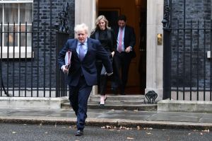An image collage containing 1 images, Image 1 shows Boris Johnson and Cleo Watson leaving Downing Street