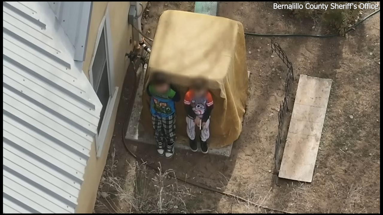 Boys, ages 7 and 9, seen in armed standoff receiving assistance from deputies