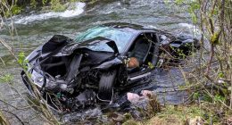 Severely damaged Ferrari in a river.