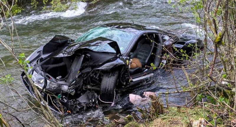 Severely damaged Ferrari in a river.
