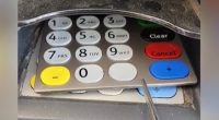 Image of a card reader with a keypad overlay that appears to be a skimming device.