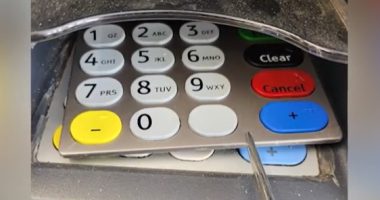 Image of a card reader with a keypad overlay that appears to be a skimming device.