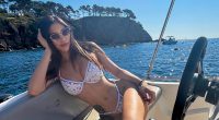 Woman in white bikini on a boat.