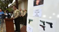 Photo of a press conference where law enforcement officials display photos of Elliot Rodger and the weapons used in the Isla Vista shooting.