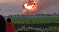Ammunition depot exploding in fireball.