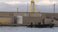 Small boat near Porto Bagnera harbor wall.