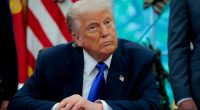 President Trump seated at a desk in the Oval Office.