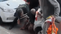 People assisting a person on the ground.