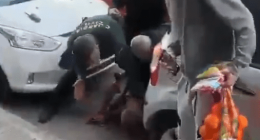 People assisting a person on the ground.