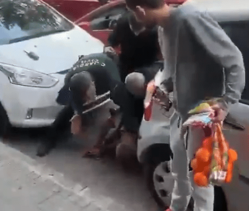 People assisting a person on the ground.