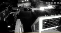 Nighttime security camera footage showing a vehicle leaving a scene.