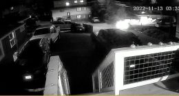 Nighttime security camera footage showing a vehicle leaving a scene.