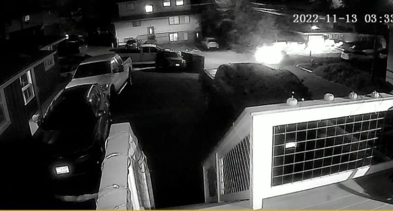Nighttime security camera footage showing a vehicle leaving a scene.