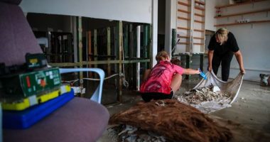 TAREE, AUSTRALIA - MAY 23: Business owners clean their shop following a flood at Albert street on May 23, 2025 in Taree, Australia. Catastrophic flooding struck the Mid North Coast and other parts of New South Wales, isolating over 50,000 residents, prompting hundreds of rescues, and leaving at least one person dead and several missing as emergency services responded to record-breaking rainfall. (Photo by Roni Bintang/Getty Images)