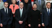 A cropped photo shows Ursula von der Leyen and António Costa standing behind Emmanuel Macron, Sir Keir Starmer, Volodymyr Zelenskyy and Donald Tusk during a summit held at Lancaster House in central London on March 2