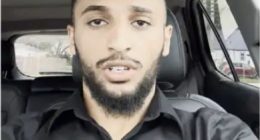 Man in a car speaking.
