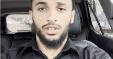 Man in a car speaking.