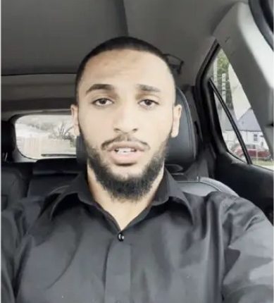 Man in a car speaking.