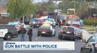 Police cars and emergency vehicles at the scene of a gun battle.