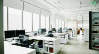 Empty office with multiple desks and computers.