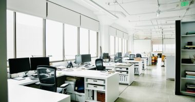 Empty office with multiple desks and computers.