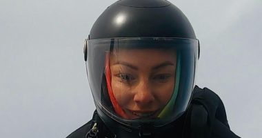 Person wearing a helmet with a camera mounted on top.