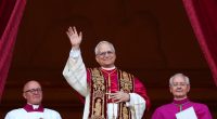 Newly elected Pope Leo XIV waving from a balcony.