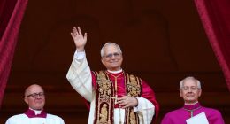 Newly elected Pope Leo XIV waving from a balcony.
