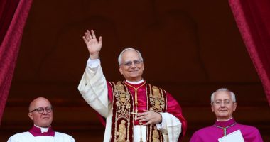 Newly elected Pope Leo XIV waving from a balcony.