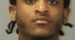 Mugshot of a young man with dark hair.
