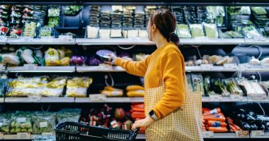 Woman shopping for produce in a supermarket.