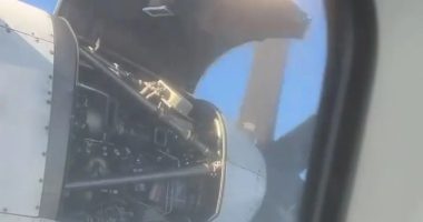 Airplane engine cover open mid-flight.