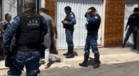 Police officers outside a house.