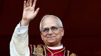 Pope Leo XIV waving from a balcony.