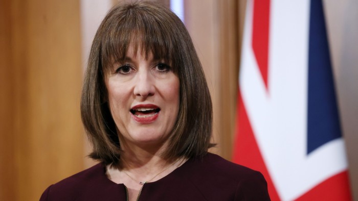 Rachel Reeves standing next to a union jack