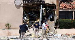 FBI agents collecting evidence at a bomb-damaged reproductive health facility.