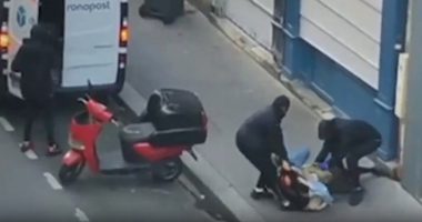 Footage of three masked men forcing a woman into a van.
